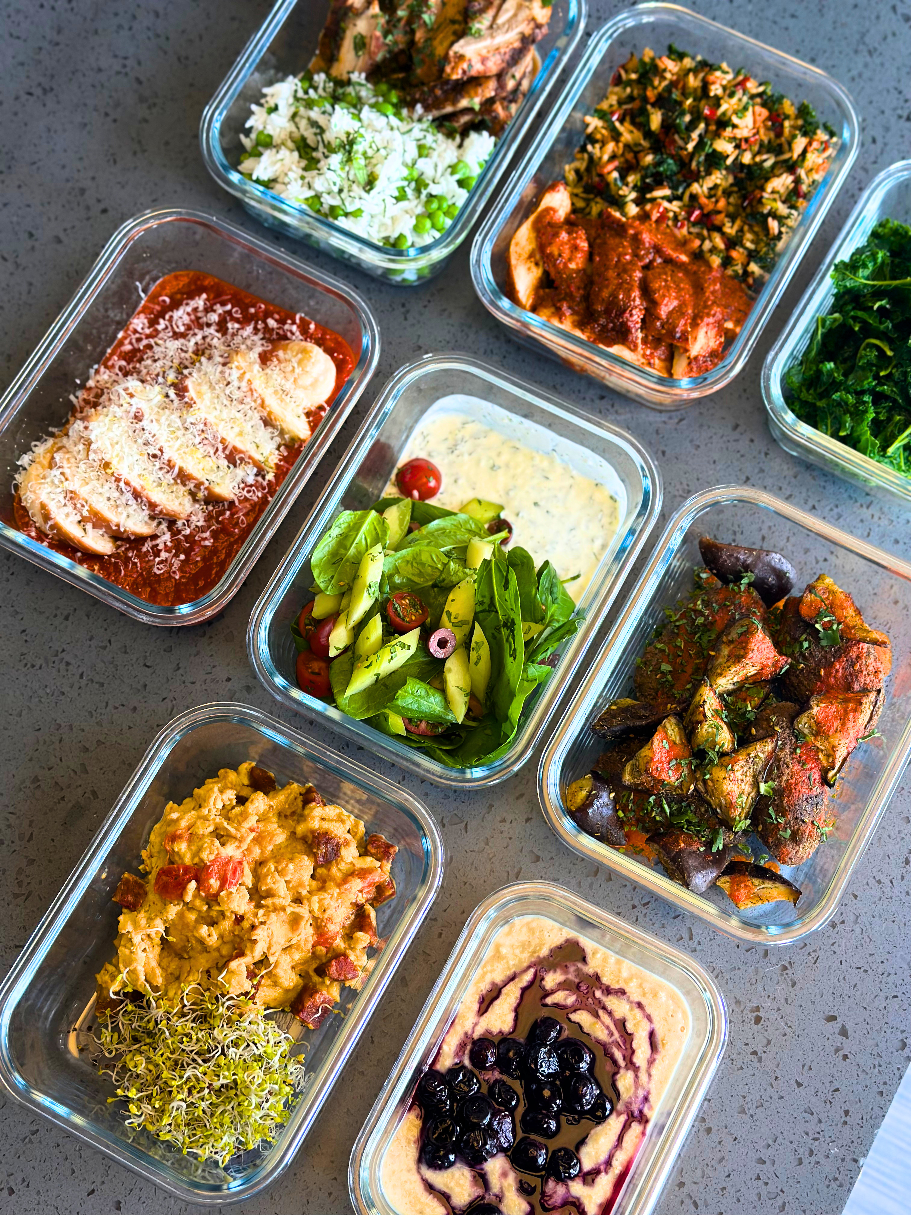 A week of personalised meals portioned into glass containers on a kitchen worktop