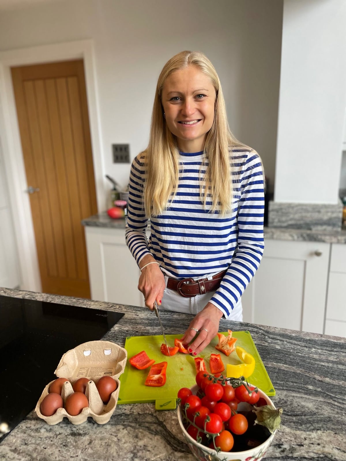 Hope, a Biospan BioChef, chopping peppers and tomatoes in a client's kitchen