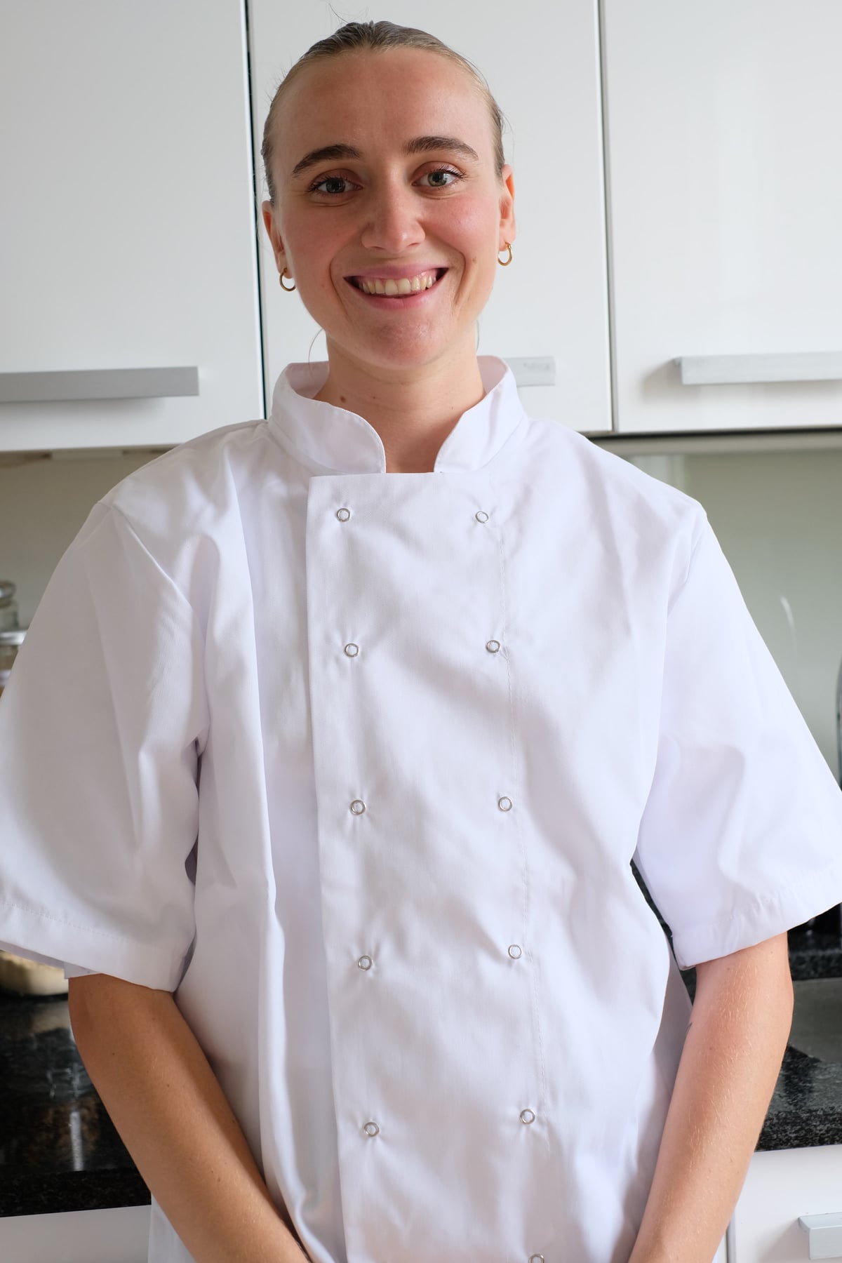 Julia, a Biospan BioChef, in chef's whites in a kitchen